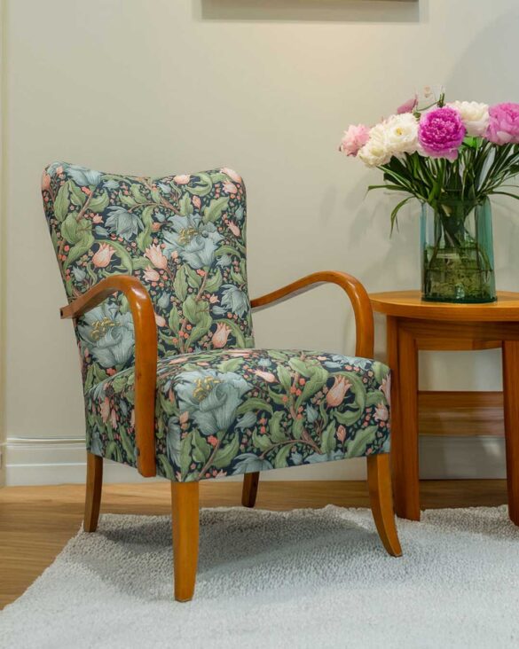 Vihreäsinisellä kukkakankaalla uudelleen verhoiltu 50-luvun tuoli.